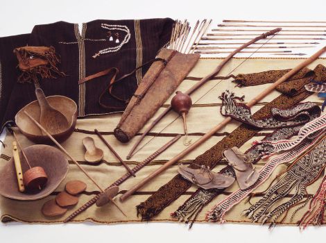 An array of Tarahumara objects, including bowls, bows, arrows, and weavings.