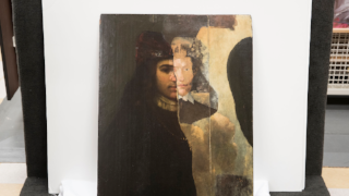 The team decided to showcase the hidden portrait as well, partially uncovered by conservator Scott Nolley. (Photo by Dan Addison, University Communications)