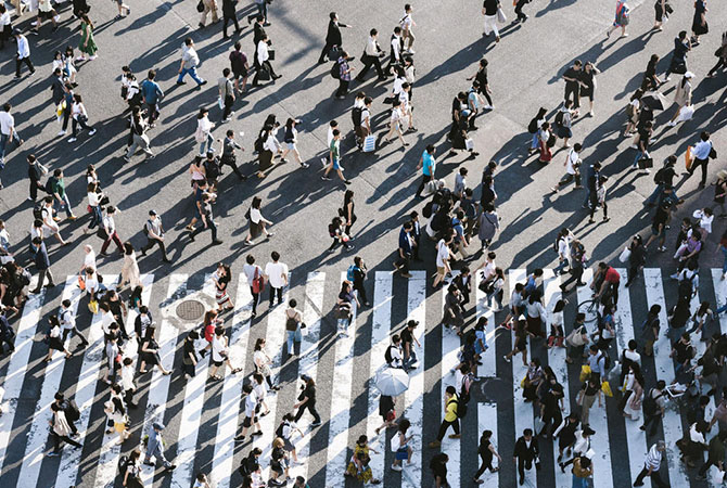 Aerial view of a crowd crossing a street.