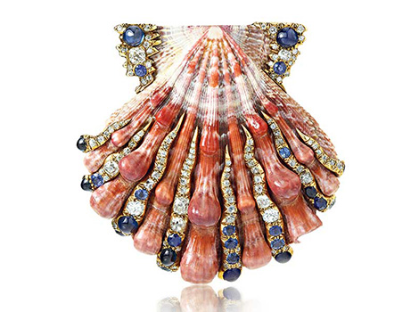 A shell brooch encrusted with gems