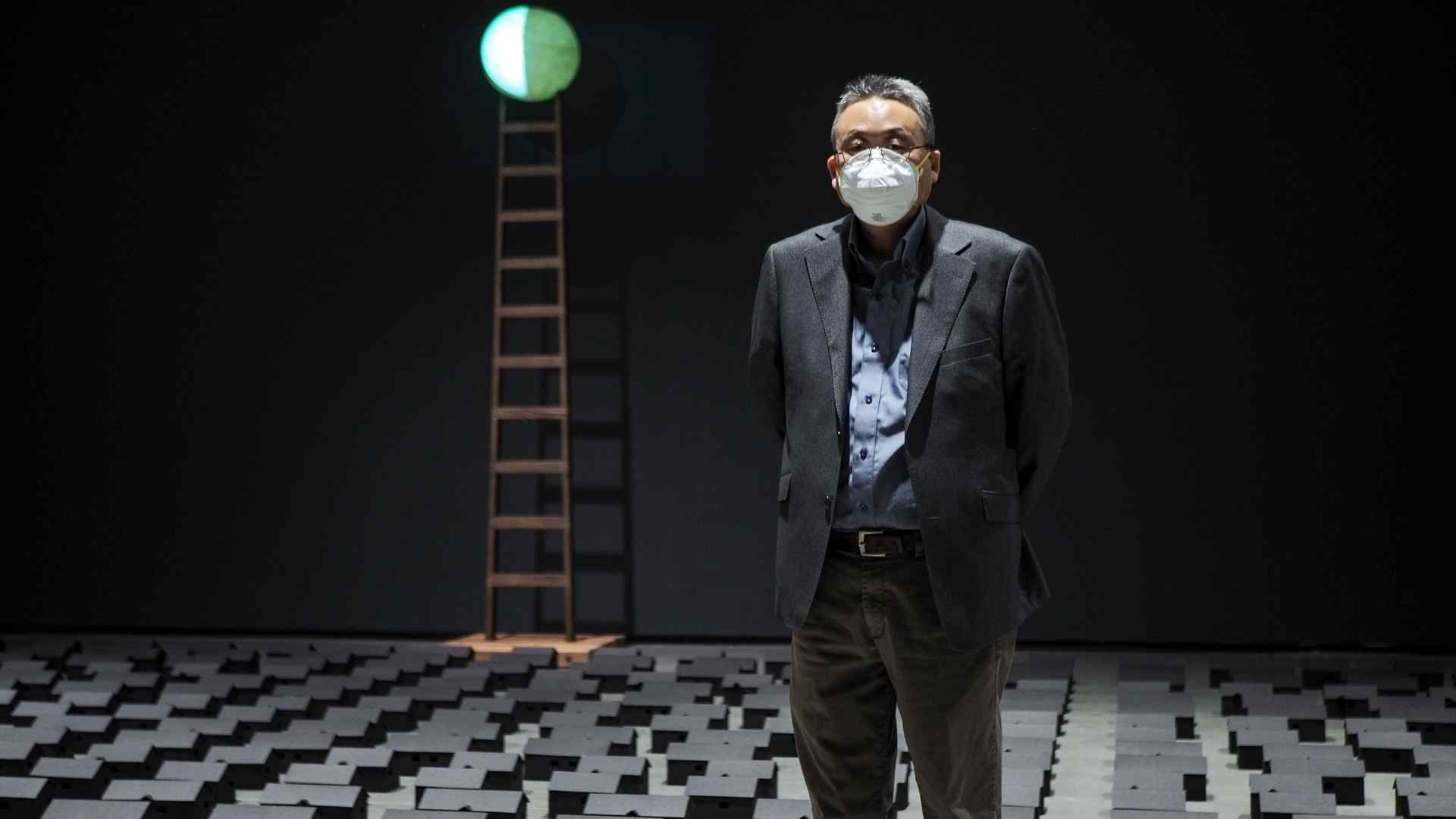 Artist Steven Nunoda standing in front of his installation 'Ghostown'.