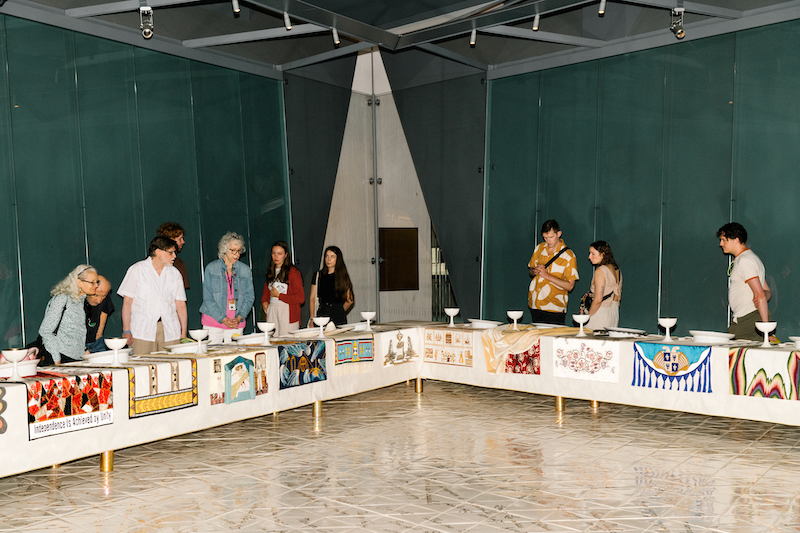 Visitors look at Judy Chicago’s “The Dinner Party”