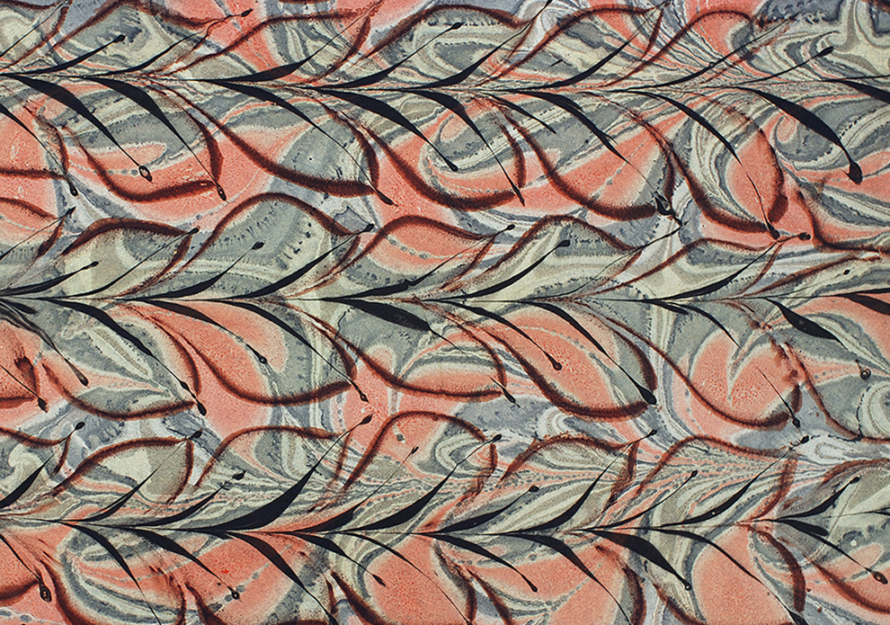 Marbled paper design with floral pattern over a marbled red blue and grey swirl.