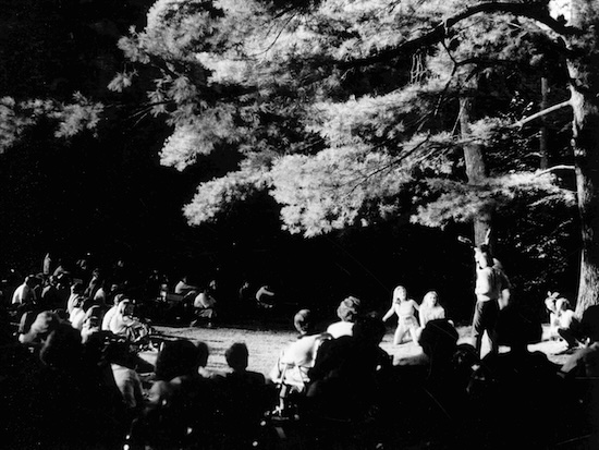 Outdoor audience at The Mount in 1978, watching Shakespeare & Company perform A Midsummer Night's Dream at night under the trees