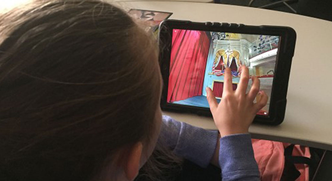  A girl looks at an image of Ford''s Theatre on an iPad. Link to distance-learning page.