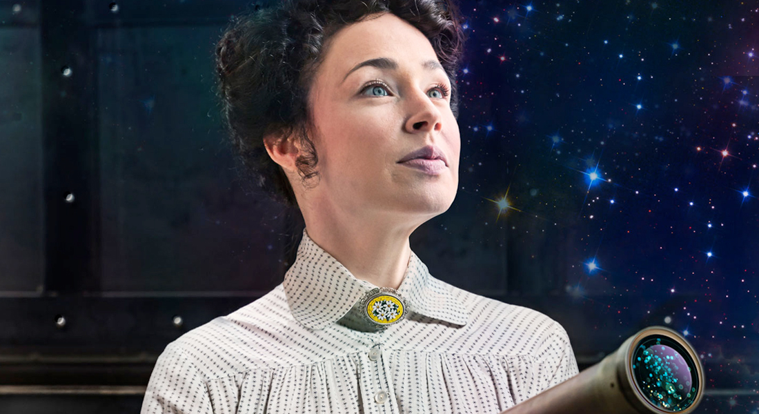 Laura C. Harris dressed in 1900s attire, gazing out in a quarter view, holding a telescope with blue, yellow and white stars in the background. Link to Get Tickets.  