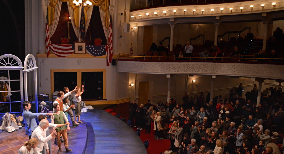 Actors on stage for curtain call at the Historic Ford's Theatre as the audience stands and applauds. Link to member pre-sale.