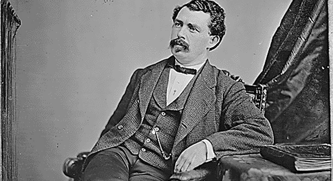 A black-and-white photograph of a man in a three-piece suit and bow tie. He has a prominent mustache and wavy hair. Link to blog post. 