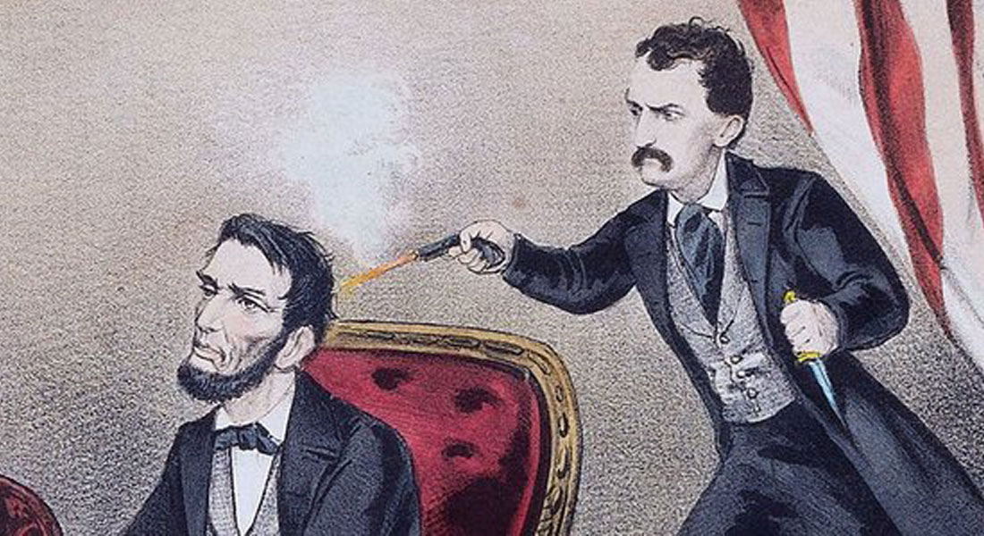 A man with a mustache shoots a bearded man in a chair with a small pistol as two women and a man react in shock.