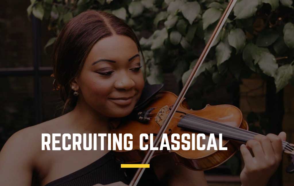 A woman with dark hair is looking down playing a violin