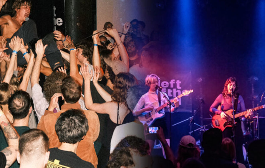A crowd is seen to the left of the picture and two guitarists are seen on the right, on a stage performing
