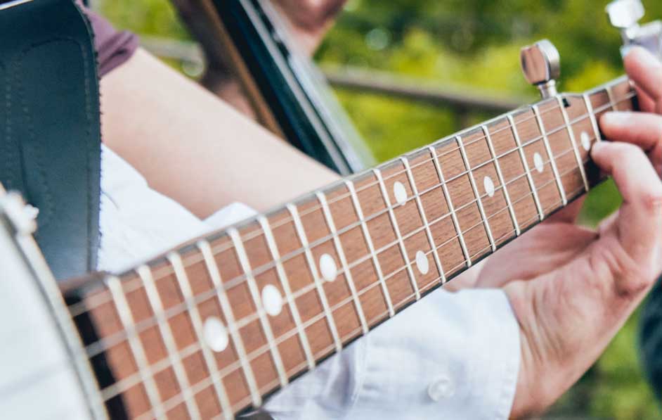 A hand is seen playing an electric guitar