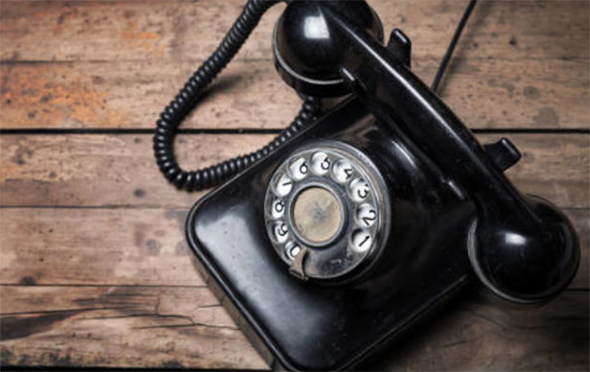 Shows an old fashioned black telephone 