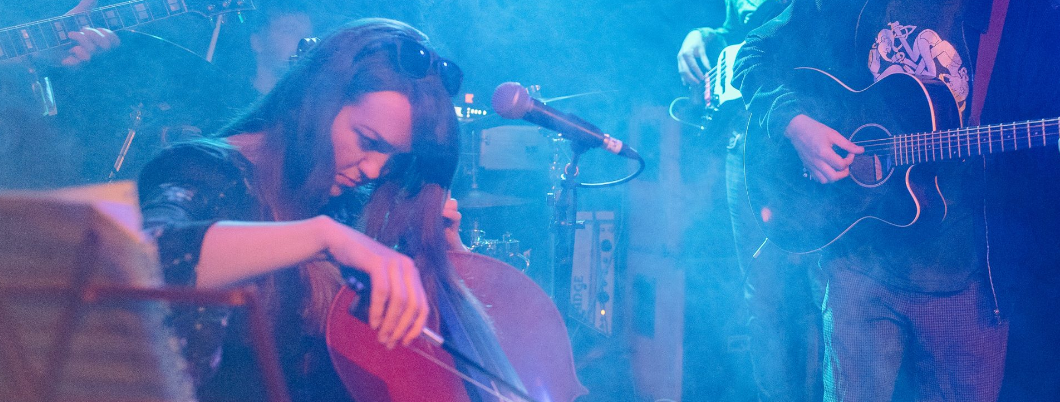 Cello player on stage with an acoustic guitar player