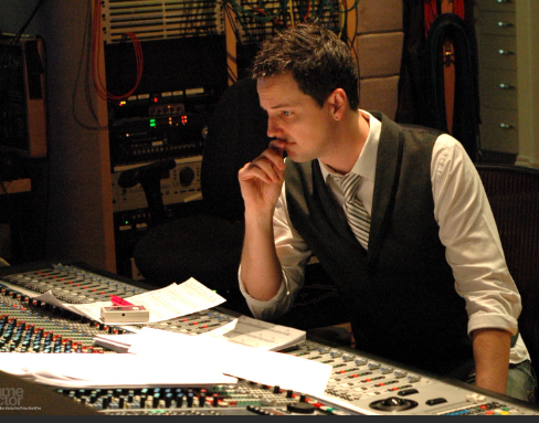 Jason Graves in is studio looking at a mixing desk