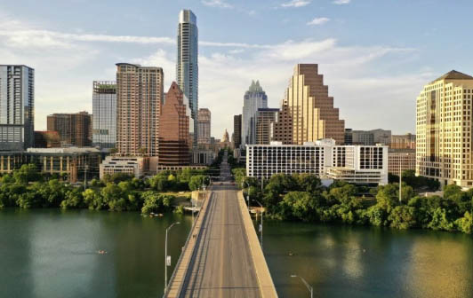 The Austin skyline is seen with a bridge leading up to it