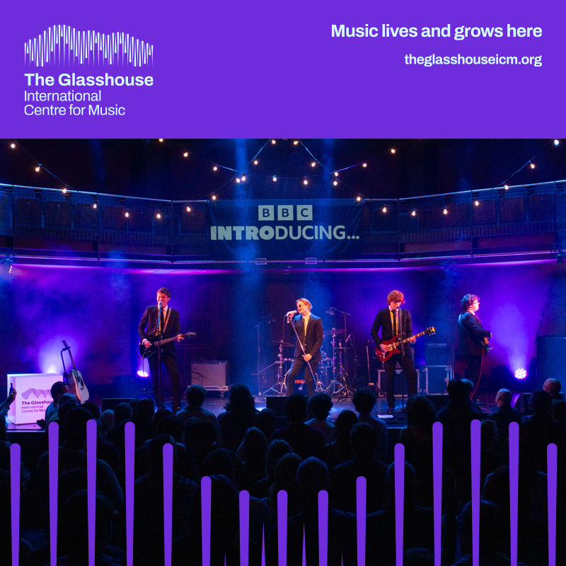 Swindled: a band of four people are performing on stage with blue lighting behind them. 