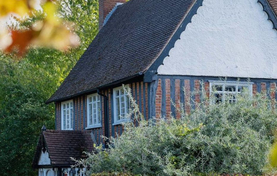A house is covered by some trees