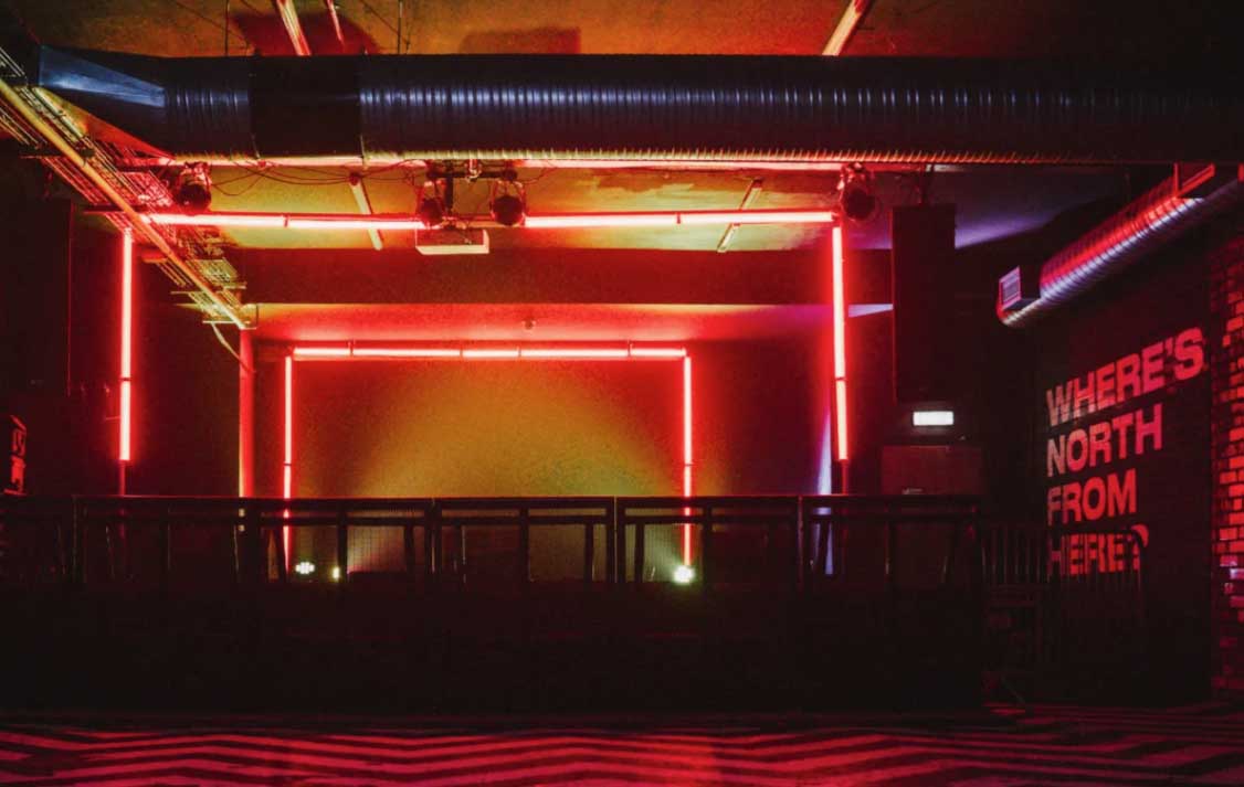 An empty stage with red and yellow lighting
