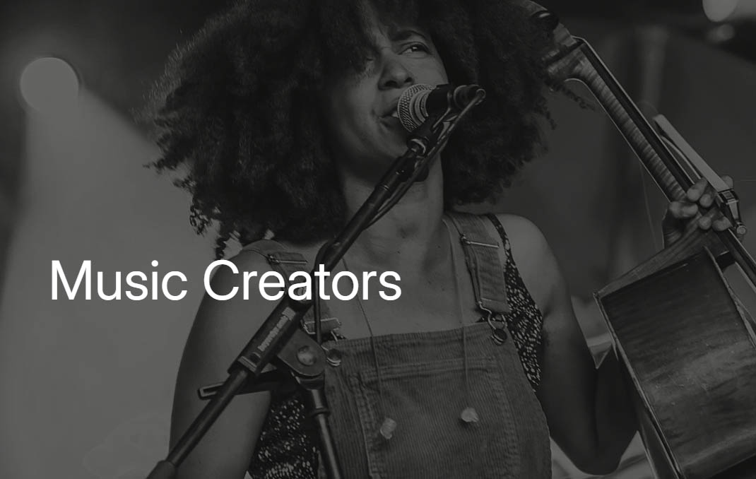 A young woman is singing into a microphone and holding an acoustic guitar next to her. The wording 'Music Creators' is written in white overtop of her image