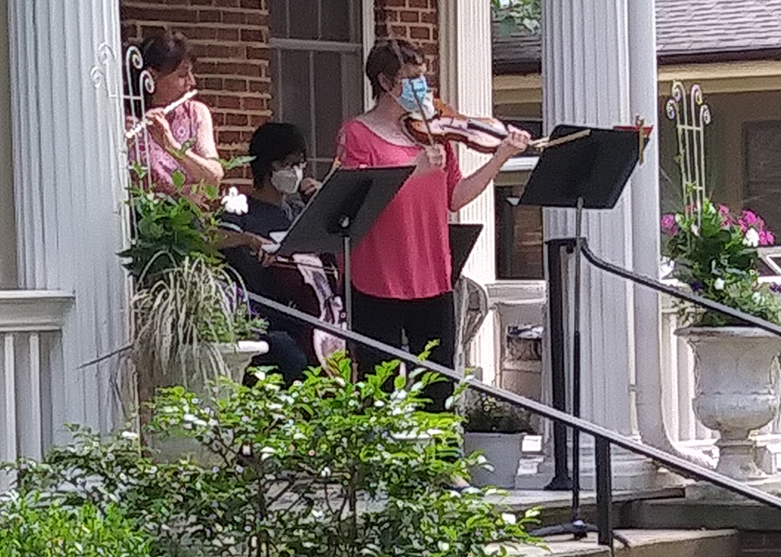Neighbors gather for a socially distanced front porch concert
