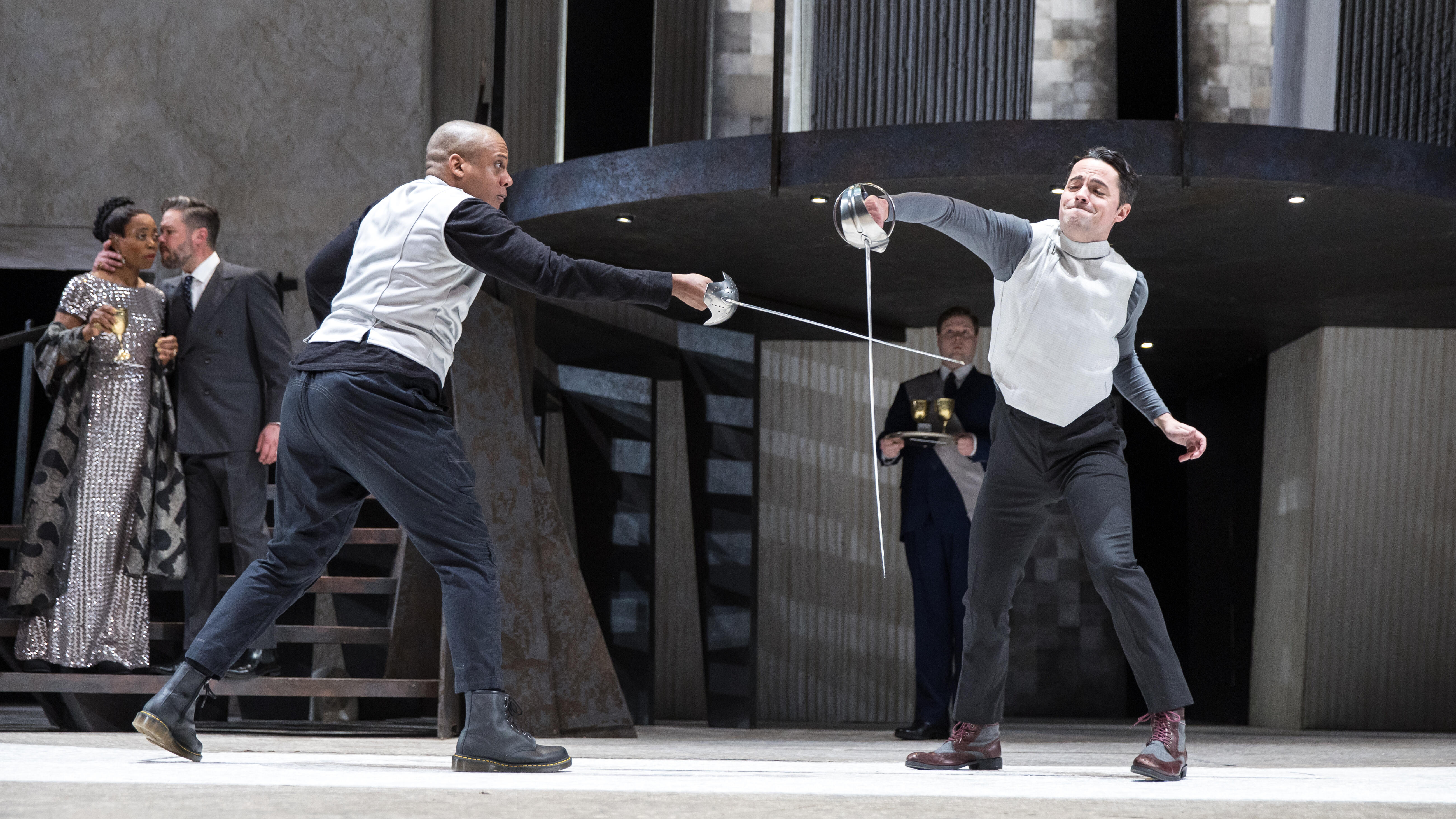 Michael Braugher as Hamlet stands onstage, arms wide, speaking.