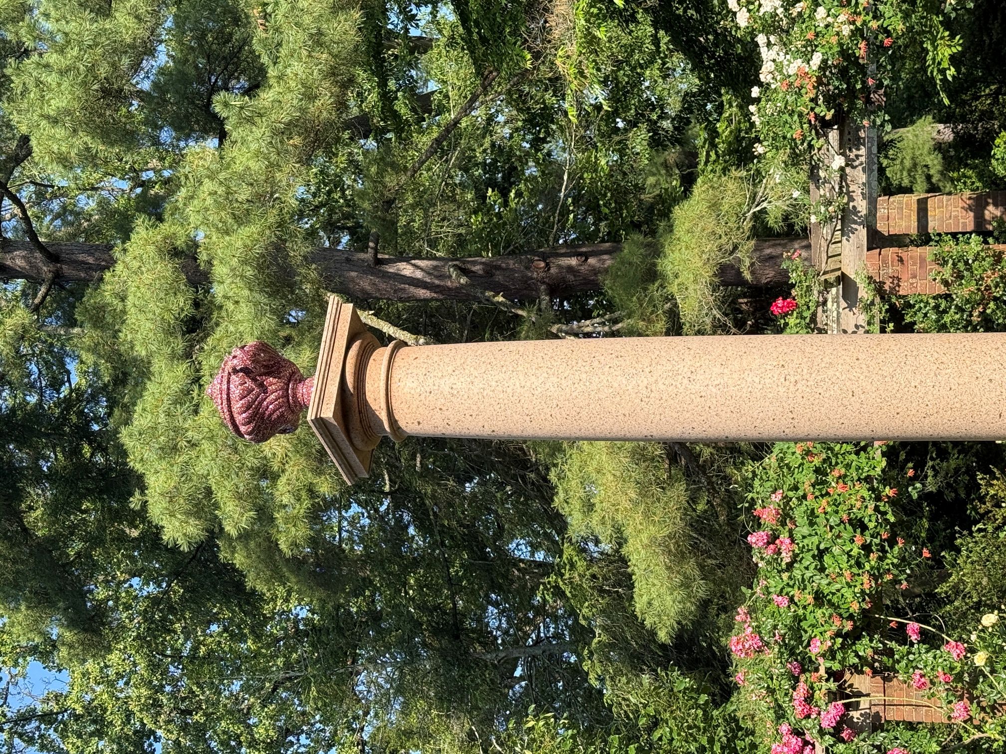 The newly installed replica urn in the rose garden.