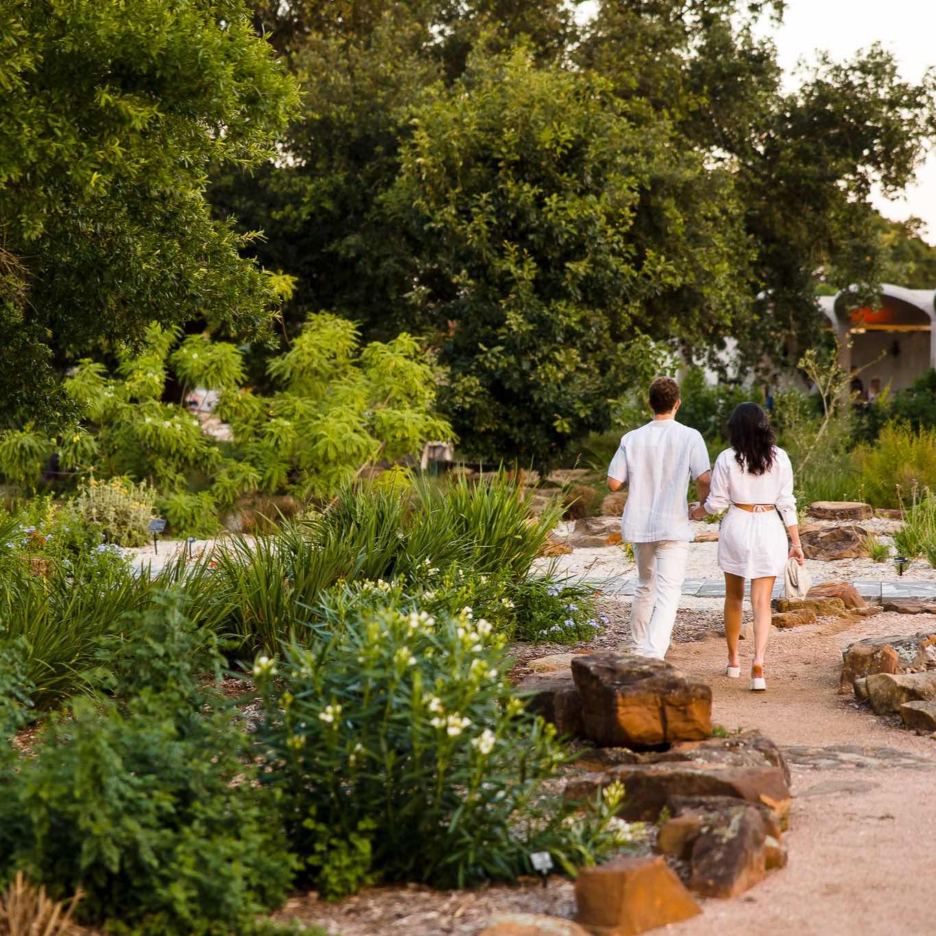 Visitors walk down a path at the Garden.