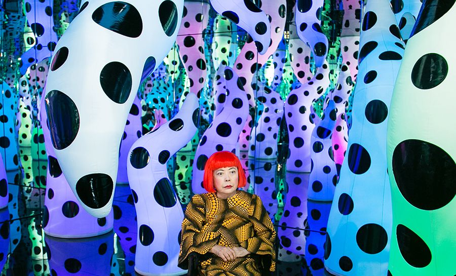 Mirrored room with multi-colored, polka-dotted, tentacle-like sculptures.