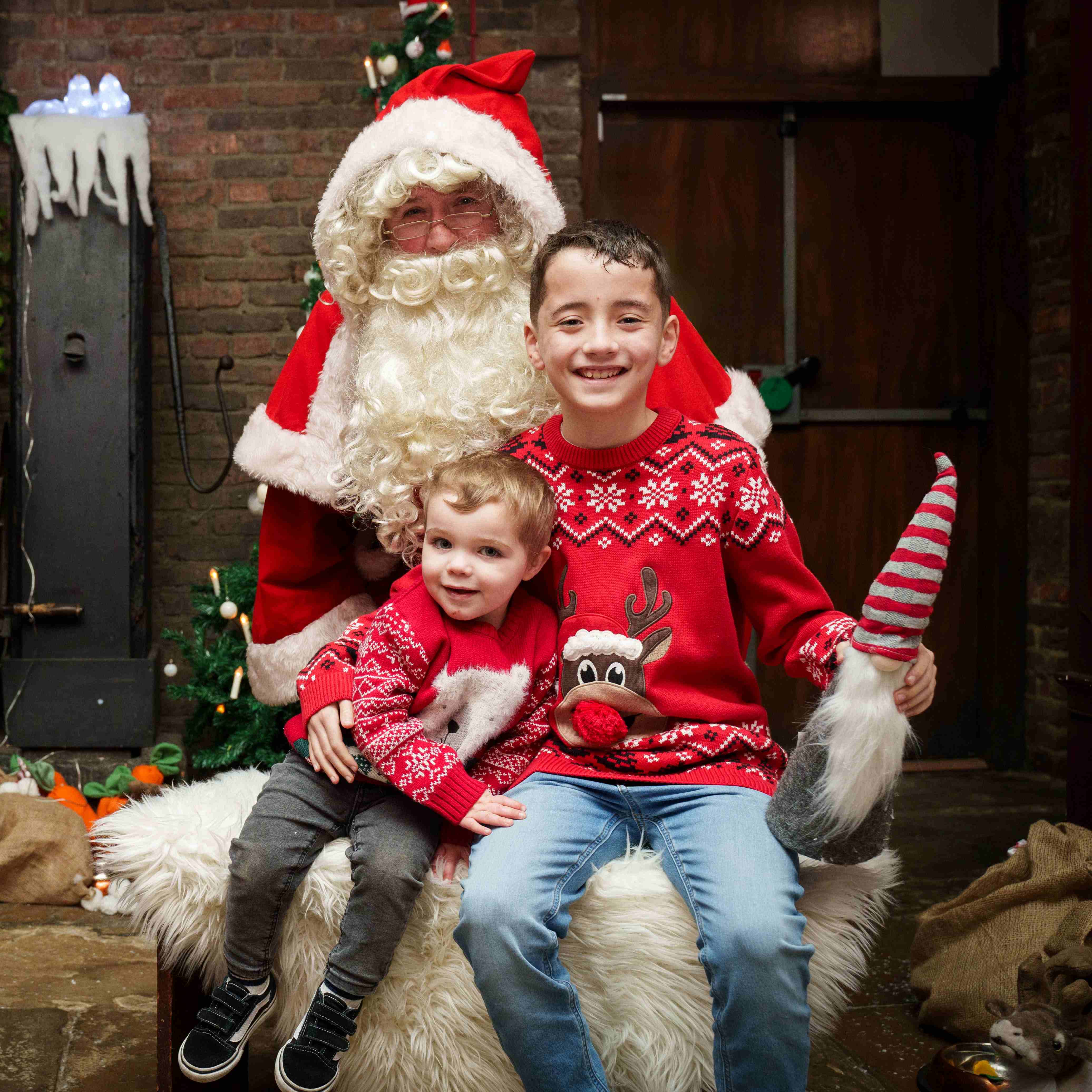 Two children sat on Santa's lap