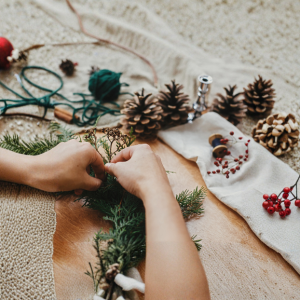 Hands making wreath