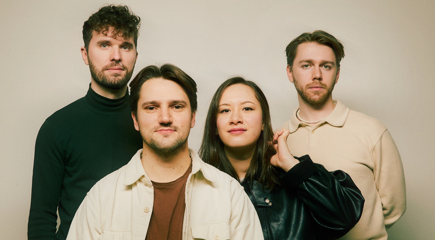 The four players of Opus13 string quartet in black and beige casual dress.