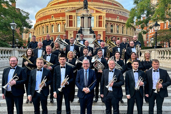 Members of the Rothwell Temperance Band in black concert dress stood on the steps outside the Royal Albert Hall with their brass instruments.