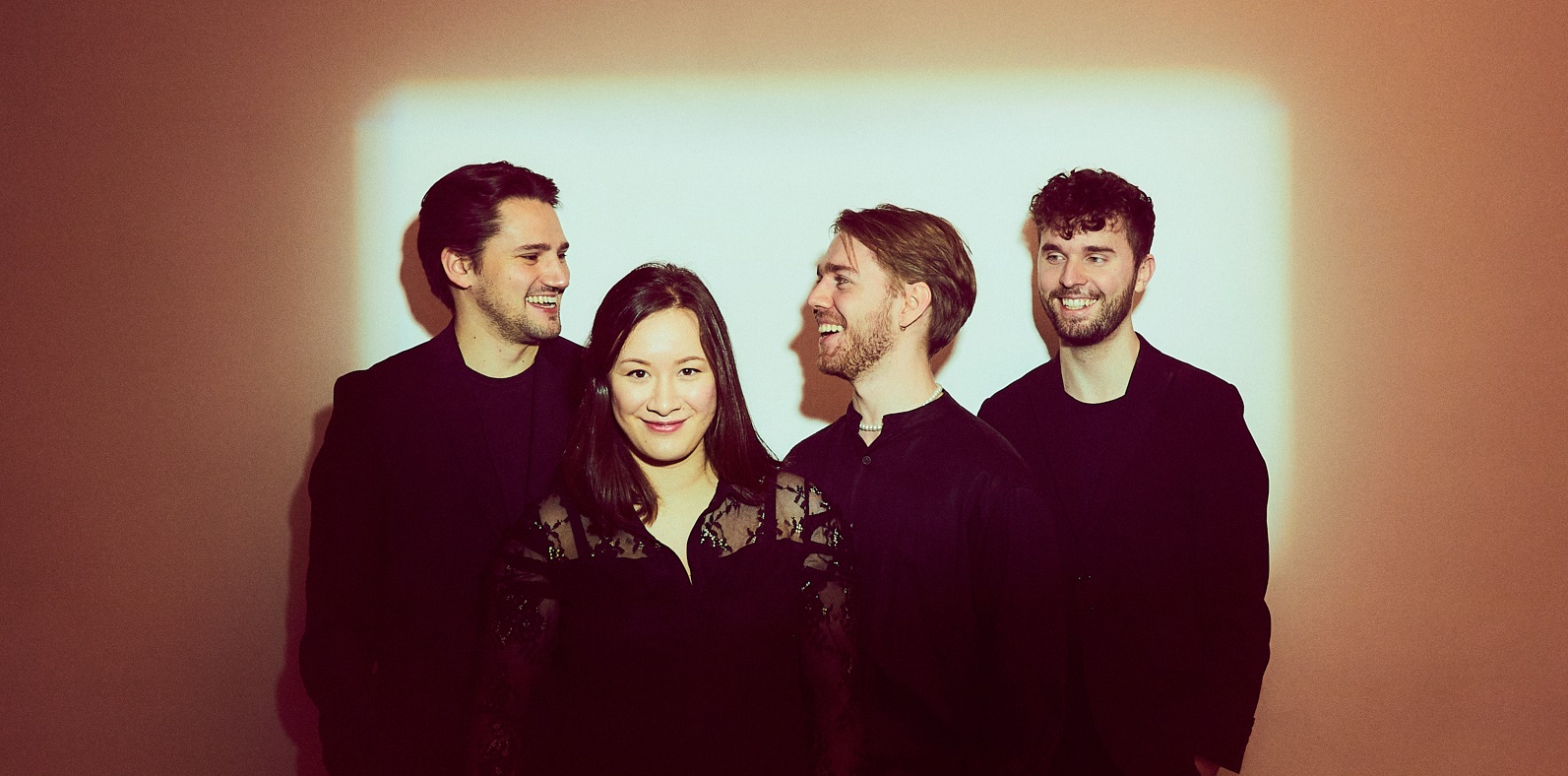 Four members of Opus13 string quartet in black concert dress.