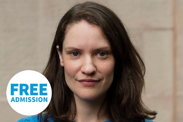 Organist Hilary Punnett in a blue top with brown shoulder length hair.