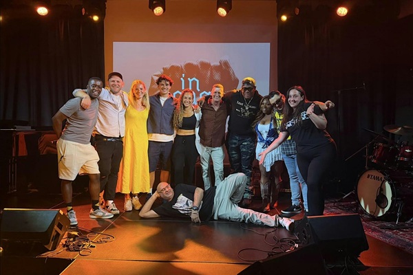 A group of people stood and laying on stage.