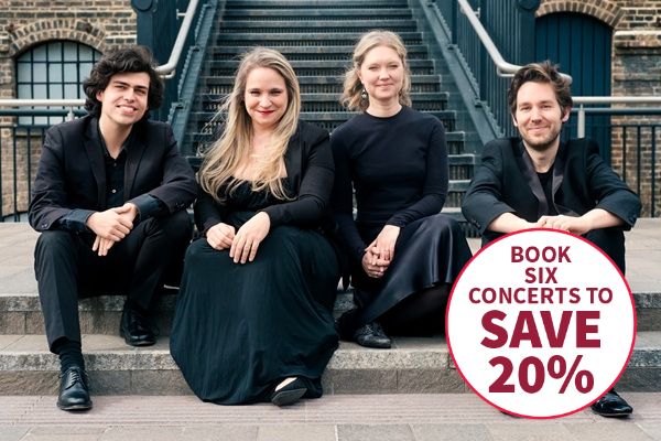 The four members of the Piatti Quartet in black clothes sat on some stone steps.