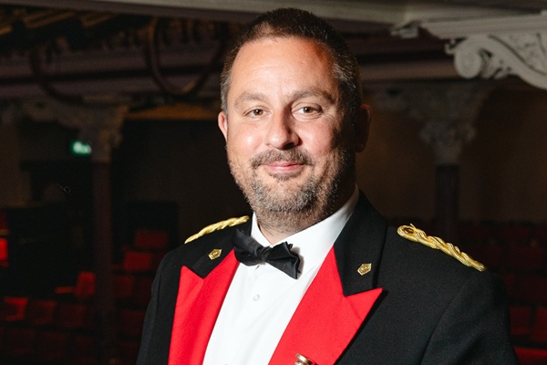 Principal Cornet player Alan Fowler in black and red concert dress.