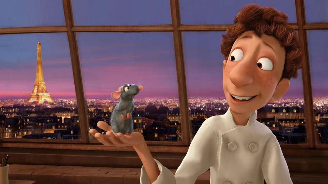 An animated chef holds a rat in his hand, the Eiffel tower in the background.