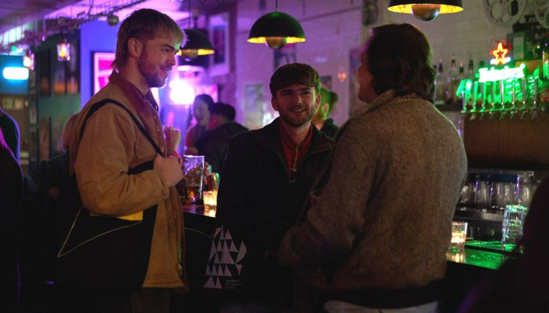 Young people socialising in bar. 