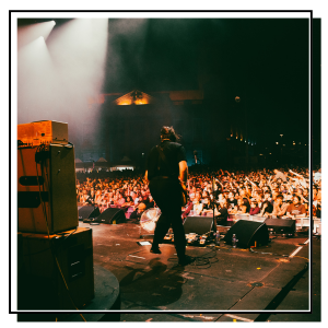 A musician playing in front of a crowd