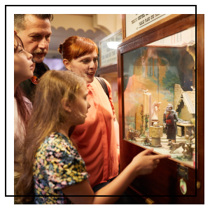 A man and child watch some deer