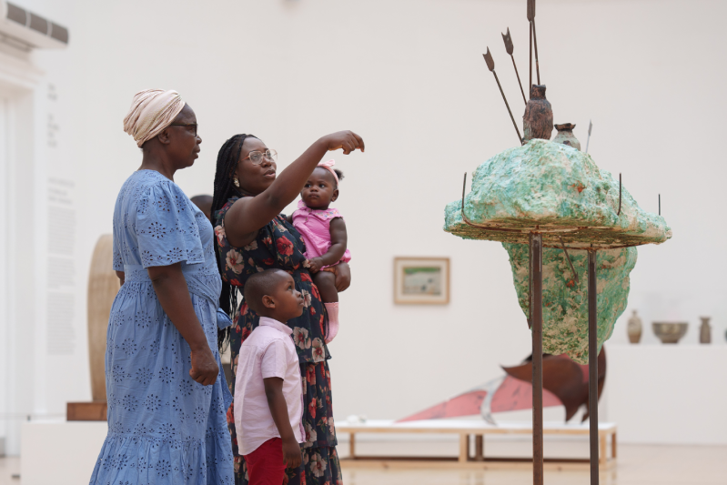 A family look at a sculpture