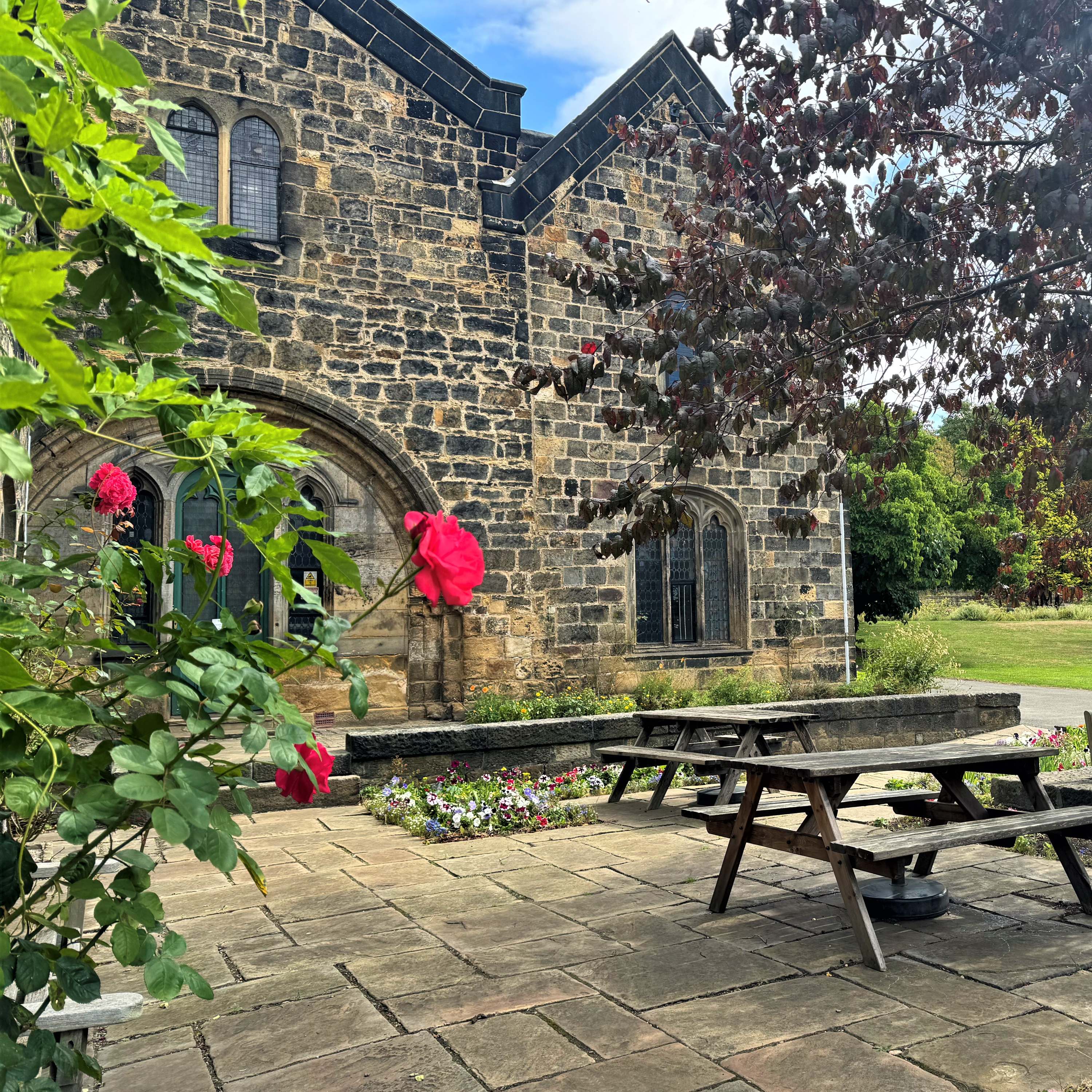 Exterior of Abbey House Museum with picnic tables in the courtyard