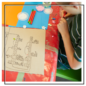 a child crafting a board game