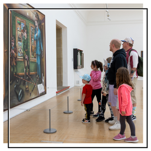 family looking at large painting