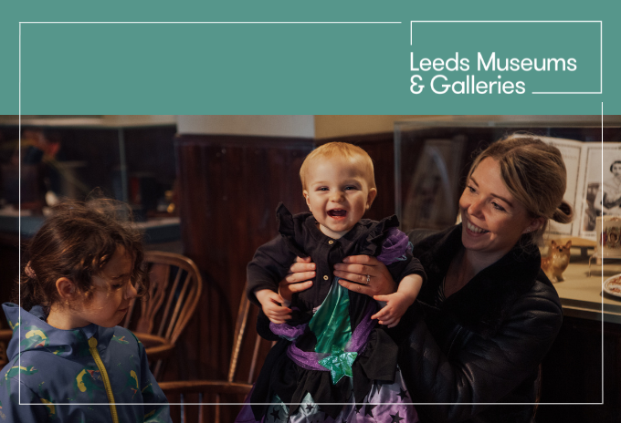 Mum holding a baby dressed in a Halloween costume