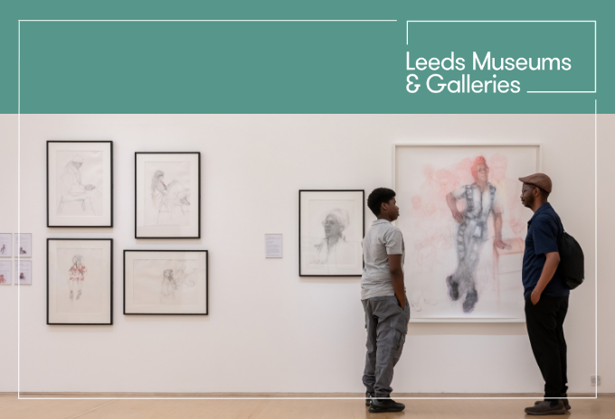 Two black men looking at each other in a gallery