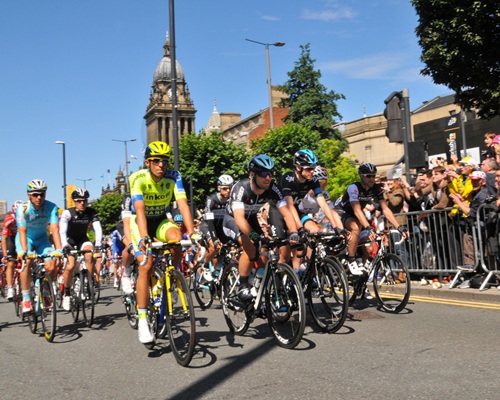 The peloton of the Tour de France grand depart cycling past Leeds Town Hall.