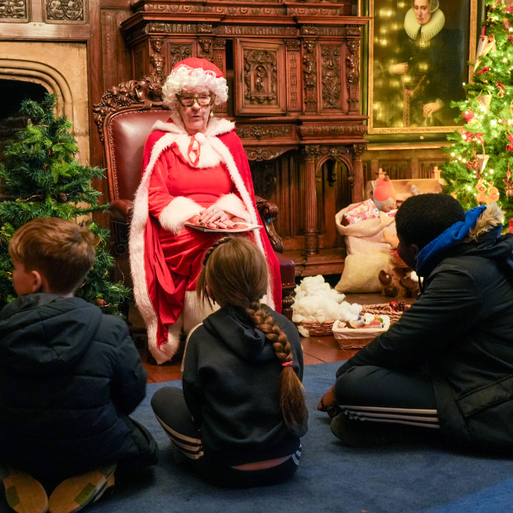 Mrs claus reading a story to a group of children